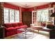 Cozy living room with red walls, windows, and a comfortable sofa at 4705 Paran Nw Vly, Atlanta, GA 30327