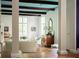 Bright living room with beamed ceilings, classic columns, and a view of the outside at 4705 Paran Nw Vly, Atlanta, GA 30327