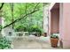 Charming patio with seating area surrounded by lush greenery and a pink stucco exterior at 4705 Paran Nw Vly, Atlanta, GA 30327