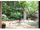 Outdoor patio with wrought iron chairs, beautiful greenery, and serene garden views at 4705 Paran Nw Vly, Atlanta, GA 30327