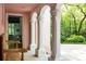 Inviting porch with classic white columns, a wooden bench, and views of the verdant yard at 4705 Paran Nw Vly, Atlanta, GA 30327