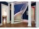 Elegant staircase with white columns and wood floors adjacent to the entry and dining room at 4705 Paran Nw Vly, Atlanta, GA 30327