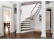 Staircase with white walls, hardwood floors, decorative pillars, and natural light at 4705 Paran Nw Vly, Atlanta, GA 30327