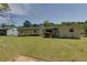 Back exterior of home showcasing a patio and large, manicured yard at 1987 Darrell Dr, Marietta, GA 30066