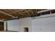 Unfinished basement with fireplace, concrete floor, white walls and exposed ceiling at 1987 Darrell Dr, Marietta, GA 30066