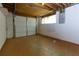 Unfinished basement with white cinder block walls, windows, and garage door access at 1987 Darrell Dr, Marietta, GA 30066