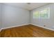 This bedroom features neutral walls, hardwood floors, and a window for natural light at 1987 Darrell Dr, Marietta, GA 30066