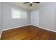 This bedroom features a ceiling fan, hardwood floors, and a window for natural light at 1987 Darrell Dr, Marietta, GA 30066