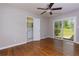 Bedroom featuring hardwood flooring, ceiling fan, ensuite bathroom, and sliding glass doors at 1987 Darrell Dr, Marietta, GA 30066