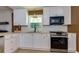 This kitchen features a stainless range, white subway tile backsplash, and light countertops at 1987 Darrell Dr, Marietta, GA 30066