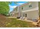 Spacious backyard with a patio, lawn, and views of the home's exterior at 261 Venture Path, Hiram, GA 30141