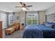 Bright bedroom with a tufted headboard, natural light, and a comfortable leather chair at 261 Venture Path, Hiram, GA 30141