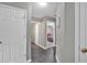 Hallway featuring multiple doorways leading to various rooms in the home at 261 Venture Path, Hiram, GA 30141