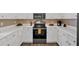 The kitchen features white cabinets with stainless steel appliances and stylish countertops at 261 Venture Path, Hiram, GA 30141