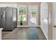 Bright kitchen featuring a stainless steel refrigerator, wood floor, and natural light at 261 Venture Path, Hiram, GA 30141
