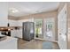 Bright kitchen featuring a stainless steel refrigerator, white cabinets, and wood floor at 261 Venture Path, Hiram, GA 30141