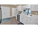 Bright kitchen features white cabinets, stainless appliances, and adjacent spaces at 261 Venture Path, Hiram, GA 30141