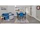 Bright living room featuring stylish furniture, modern flooring, and an open layout to the dining area at 261 Venture Path, Hiram, GA 30141