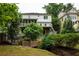 Expansive backyard featuring a deck, screened porch, bridge and mature trees at 331 Gordon Ne Ave, Atlanta, GA 30307