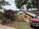 Funky backyard greenhouse/shed adorned with colorful sunflower art and vibrant landscaping at 331 Gordon Ne Ave, Atlanta, GA 30307