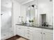 Modern bathroom featuring dual sinks with granite countertops, vanity, large mirrors, and a glass-enclosed shower at 331 Gordon Ne Ave, Atlanta, GA 30307