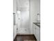 Bright bathroom showcases a walk-in shower with a glass door, white subway tiles, and a dark wood floor at 331 Gordon Ne Ave, Atlanta, GA 30307