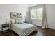 Cozy bedroom features hardwood floors, large windows, bedside tables, and a comfortable bed with stylish linens at 331 Gordon Ne Ave, Atlanta, GA 30307