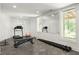 Bright home gym with treadmill, weight bench, dumbbells, and a large mirrored wall at 331 Gordon Ne Ave, Atlanta, GA 30307