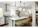 Modern kitchen with stainless steel appliances, island with seating, and stylish pendant lighting at 331 Gordon Ne Ave, Atlanta, GA 30307
