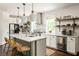 Bright kitchen featuring a large island with seating, pendant lights, and stainless steel appliances at 331 Gordon Ne Ave, Atlanta, GA 30307
