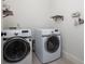 Functional laundry room with front load washer and dryer, with open shelving for storage and organization at 331 Gordon Ne Ave, Atlanta, GA 30307