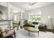 Stylish living room with green sofa, neutral armchair, and abundant natural light at 331 Gordon Ne Ave, Atlanta, GA 30307