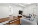 Comfortable living room features gray sectional, steps leading to bathroom, and a flatscreen TV at 331 Gordon Ne Ave, Atlanta, GA 30307