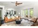 Open living room with hardwood floors, a ceiling fan, and access to an outdoor deck at 331 Gordon Ne Ave, Atlanta, GA 30307