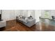 Spacious living room with a comfortable gray sofa, wood floors, and neutral walls at 331 Gordon Ne Ave, Atlanta, GA 30307