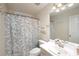 Charming bathroom featuring floral shower curtain, white vanity, and a well-lit mirror at 332 Red Fox Dr, Canton, GA 30114
