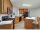 Well-lit kitchen features updated appliances, wood cabinets, and a cozy breakfast bar at 332 Red Fox Dr, Canton, GA 30114