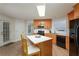 Well-appointed kitchen features wood cabinets, black appliances, and a breakfast bar at 332 Red Fox Dr, Canton, GA 30114