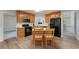 A well-lit kitchen with wooden cabinets, black appliances and island with chairs at 332 Red Fox Dr, Canton, GA 30114
