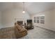 Bright living room featuring a fireplace, high ceilings, and comfortable seating arrangement at 332 Red Fox Dr, Canton, GA 30114