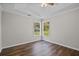 Serene bedroom with hardwood floors, ceiling fan, and natural light from two windows at 2035 Mountain Rd, Cumming, GA 30040