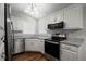 Modern kitchen featuring stainless steel appliances, granite countertops, and white cabinets at 2035 Mountain Rd, Cumming, GA 30040