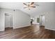 Open living room with hardwood floors, ceiling fan, and seamless flow into the kitchen at 2035 Mountain Rd, Cumming, GA 30040