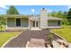 Charming single-story home featuring a cozy rear patio, chimney and neutral siding, nestled in a serene, wooded neighborhood at 2035 Mountain Rd, Cumming, GA 30040