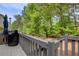 View from the wooden deck and railing of the mature trees in the yard at 376 Eagle Tiff Dr, Sugar Hill, GA 30518
