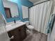 Bathroom featuring wood-look floors, updated vanity, and framed mirror at 376 Eagle Tiff Dr, Sugar Hill, GA 30518