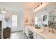Modern bathroom with double sinks, large vanity mirror, and a glass enclosed shower with soaking tub at 376 Eagle Tiff Dr, Sugar Hill, GA 30518
