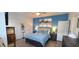 Well-lit bedroom features wood-look floors, a stylish accent wall, and coordinated decor at 376 Eagle Tiff Dr, Sugar Hill, GA 30518