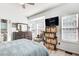 Bright primary bedroom includes a dresser, media center, and a large bay window at 376 Eagle Tiff Dr, Sugar Hill, GA 30518