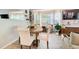 Dining area with wood table and chairs, natural light, and easy access to the living room at 376 Eagle Tiff Dr, Sugar Hill, GA 30518